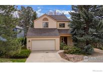 Charming two-story home with a well-maintained front yard and a two-car attached garage at 851 Racquet Ln, Boulder, CO 80303