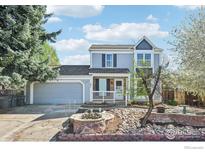 Charming two-story home with well-manicured yard and attached two-car garage at 951 Vetch Cir, Lafayette, CO 80026