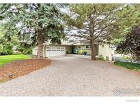 Charming single-Gathering home featuring a large driveway, two-car garage, mature trees and covered front deck at 1247 Westview Dr, Boulder, CO 80303