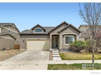 Charming single-Gathering home with a well-maintained lawn, neutral stucco, and a two-car garage at 12853 E 108Th Ave, Commerce City, CO 80022