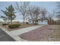 Charming single-story home with a well-maintained lawn, mature trees, and a quaint, inviting curb appeal at 1498 Wicklow St, Boulder, CO 80303