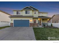 Charming two-story home with a well-manicured lawn, inviting porch, and a two-car garage at 16315 9Th St, Mead, CO 80542