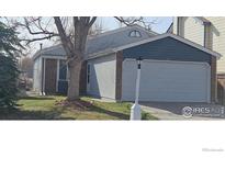 Charming single-Gathering home with attached garage, brick accents, and well-maintained lawn at 1929 Juniper St, Longmont, CO 80501