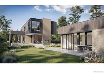 Modern home featuring a brick chimney, large windows, gray siding, and a beautifully landscaped yard at 2090 Orchard Ave, Boulder, CO 80304
