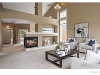 Inviting living room with fireplace, vaulted ceiling, and natural light at 3122 Notabon Ct, Lafayette, CO 80026
