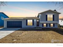 Charming two-story home featuring a gray exterior, attached garage, and well-manicured lawn at 4752 E 108Th Pl, Thornton, CO 80233