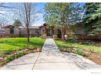 Charming home featuring a well-maintained lawn, mature trees, and a welcoming walkway to the front door at 1533 Old Tale Rd, Boulder, CO 80303