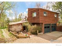 Unique two-story home with wood exterior, attached two-car garage, and lush landscaping at 1800 Sumac Ave, Boulder, CO 80304