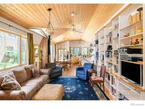 Bright living room featuring hardwood floors, built in bookshelves, and an open concept floor plan at 1800 Sumac Ave, Boulder, CO 80304