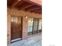 Brick apartment building entrance featuring a brown door and sliding glass window with unit number 1961 at 1961 Centennial Dr, Louisville, CO 80027