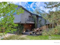 Charming two-story home with a deck, balcony, and mature landscaping creating inviting outdoor spaces at 2212 Juniper Ct, Boulder, CO 80304