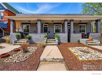 Charming duplex with inviting front porches, landscaped with stone and mulch, providing curb appeal at 2955 N Columbine St, Denver, CO 80205