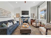 Bright living room featuring a decorative fireplace, comfortable seating, and stylish decor creating an inviting atmosphere at 2955 N Columbine St, Denver, CO 80205