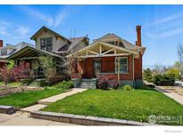 Attractive home with lush green lawn and inviting curb appeal on a sunny day at 3059 N York St, Denver, CO 80205