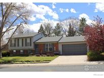 Lovely split-level home with a well-manicured front lawn and a two-car garage at 308 Baron Ave, Lafayette, CO 80026