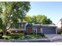 Charming two-story home with brick accents, manicured lawn, and mature shade trees at 308 Baron Ave, Lafayette, CO 80026