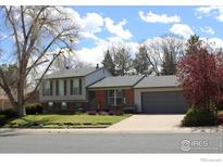 Charming two-story home with attached garage and well-maintained front yard landscaping at 308 Baron Ave, Lafayette, CO 80026