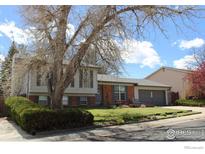 Charming split-level home with brick accents, mature landscaping, and a two-car garage at 308 Baron Ave, Lafayette, CO 80026