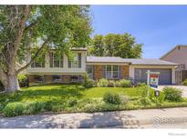 Charming two-story home features a landscaped front yard, brick accents, and a 'For Sale' sign at 308 Baron Ave, Lafayette, CO 80026