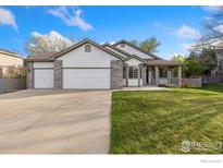 Charming single-Gathering home with a three-car garage and a well-maintained front yard at 329 Marmot Pt, Lafayette, CO 80026