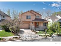 Charming two-story home with a well-maintained yard and inviting curb appeal on a sunny day at 4866 Franklin Dr, Boulder, CO 80301