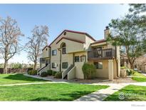 Well-maintained two-story condo featuring a balcony and lush landscaping at 5035 W 73Rd Ave, Westminster, CO 80030