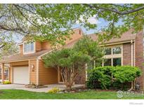 Charming two-story home featuring a well-maintained lawn, mature tree, and attached two-car garage at 5285 Gallatin Pl, Boulder, CO 80303
