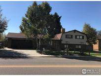 Charming two-story home featuring mature trees, a well-kept lawn, and an attached two-car garage at 536 Tipple Pkwy, Frederick, CO 80530