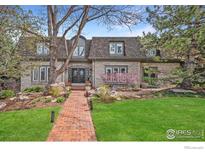 Beautiful two-story brick home with manicured lawn and brick walkway at 5442 S Dayton Ct, Greenwood Village, CO 80111