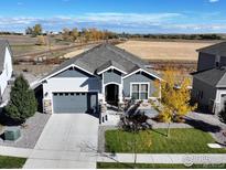 Charming single-story home featuring a well-manicured lawn, gray siding, and a two-car garage at 790 Lowrey Ln, Berthoud, CO 80513