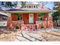 Charming brick home featuring a cozy front porch and well-manicured landscaping for curb appeal at 1114 5Th Ave, Longmont, CO 80501