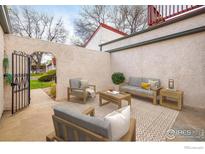 Private patio featuring outdoor seating, textured walls, and a decorative archway entrance at 1321 Madero St, Broomfield, CO 80020