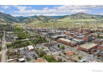 Picturesque aerial view of 1360 Walnut St with lush greenery, cityscapes, and majestic mountains in the background at 1360 Walnut St # 211, Boulder, CO 80302