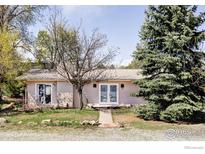 Charming single-story home featuring a well-maintained front yard and inviting entrance at 1891 Orchard Ave, Boulder, CO 80304