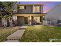 Charming two-story home featuring a well-maintained lawn and inviting front entrance at 21562 E 47Th Ave, Denver, CO 80249