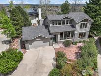 Charming grey two-story home with well-manicured landscaping, complemented by a two-car garage at 2499 Powderhorn Ln, Boulder, CO 80305