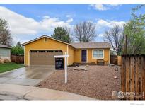Charming single-story home with a well-maintained front yard and attached garage at 593 Juniper Ct, Louisville, CO 80027