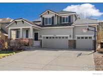 Charming two-story home featuring a three-car garage, stone accents, and well-maintained landscaping at 2208 Bellavista St, Castle Rock, CO 80109