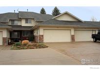 Charming townhouse with an attached garage and well-maintained landscaping at 226 S 3Rd St, Berthoud, CO 80513