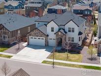 Inviting two-story home showcasing a three-car garage and well-maintained landscaping in a desirable neighborhood at 228 Horizon Ave, Erie, CO 80516