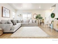 Inviting living room boasts a plush sectional, ample natural light, and stylish decor for a cozy atmosphere at 320 Marshall Mews, Superior, CO 80027