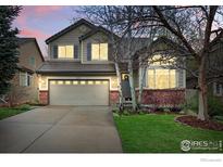 Charming two-story home featuring a two-car garage, brick accents, and manicured front lawn at 3235 Basalt Ct, Superior, CO 80027