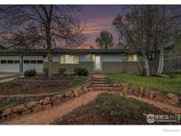 Charming single-story home with beautiful landscaping and a stone pathway leading to the front door at 339 Indiana Ave, Berthoud, CO 80513
