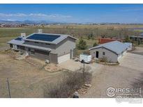 Ranch home with solar panels, garage, outbuilding, and mountain views at 524 E County Road 8, Berthoud, CO 80513
