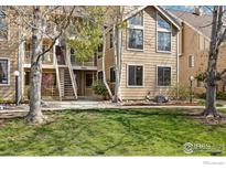Inviting exterior view of a multi-story home with beautiful birch trees and well-maintained landscaping at 5934 Gunbarrel Ave # D, Boulder, CO 80301