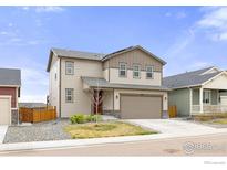 Two-story home featuring neutral siding, a two-car garage and tidy landscaping at 6131 Easton Cir, Frederick, CO 80504