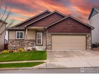 Charming single-Gathering home featuring a two-car garage, stone accents, and a well-maintained lawn at 6659 12Th St, Frederick, CO 80530