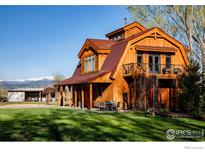 Beautifully crafted wood barn-style home with covered porch, balcony and mountain views at 7929 Valmont Rd, Boulder, CO 80301
