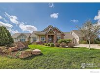 Beautiful single-Gathering home with well manicured lawn and stone accents at 8392 Niwot Meadow Farm Rd, Niwot, CO 80503
