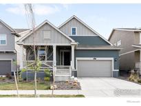 Charming home with a well-manicured lawn, front porch, and attached garage, perfect for suburban living at 840 Clover Loop, Lafayette, CO 80026